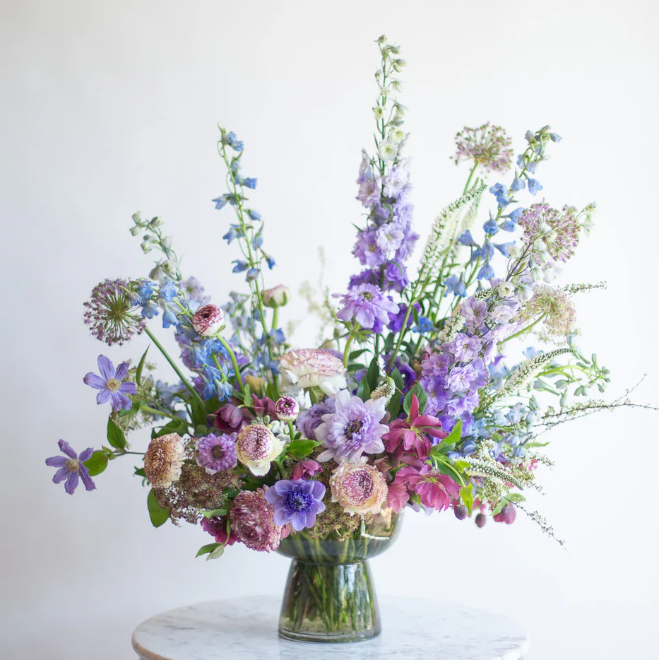 Bouquet of flowers in a vase on a marble table with a white background