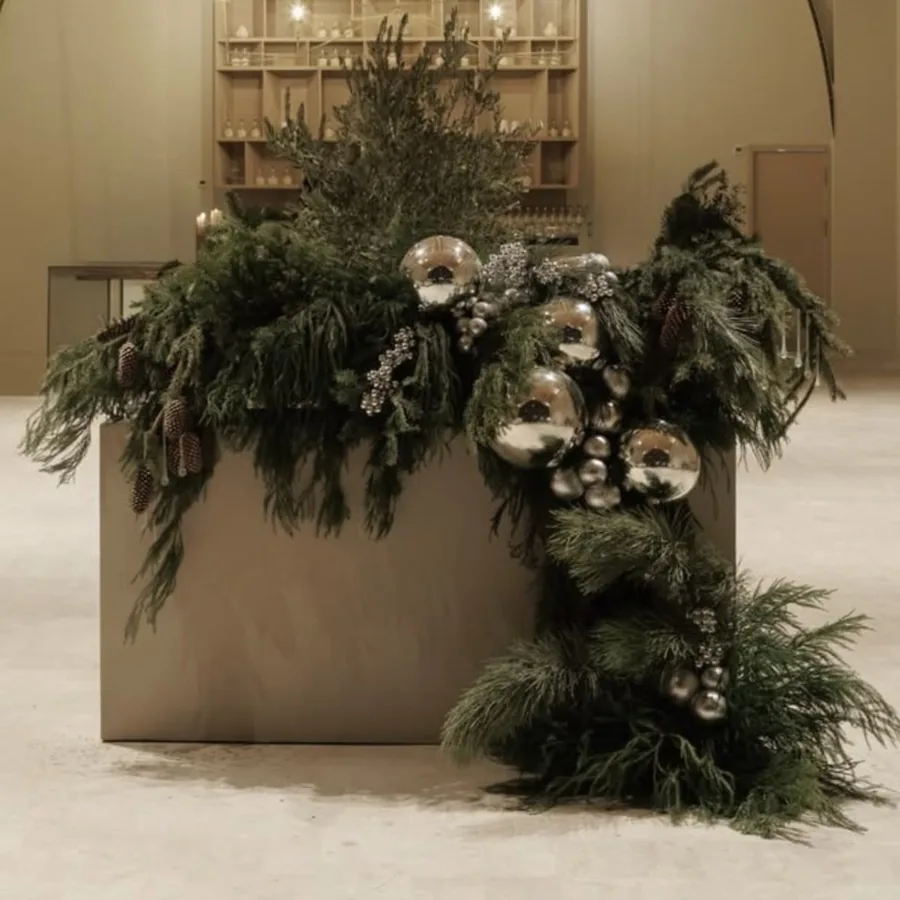 A reception planter dressed by the studio in fir, pine and silver baubles